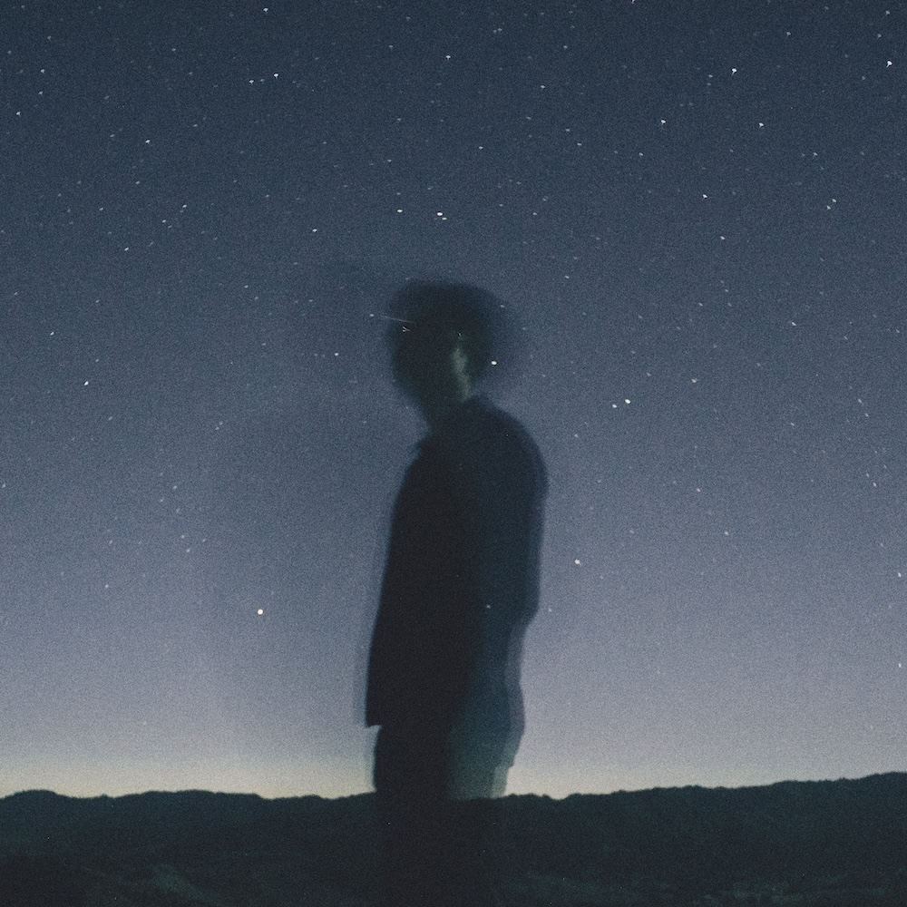 Levi Patel - Gravity cover artwork. Levi standing in profile against night sky, blurred from motion