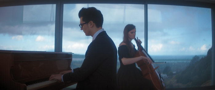 Levi Patel playing piano with a cellist, taken from Through Winter Eyes music video